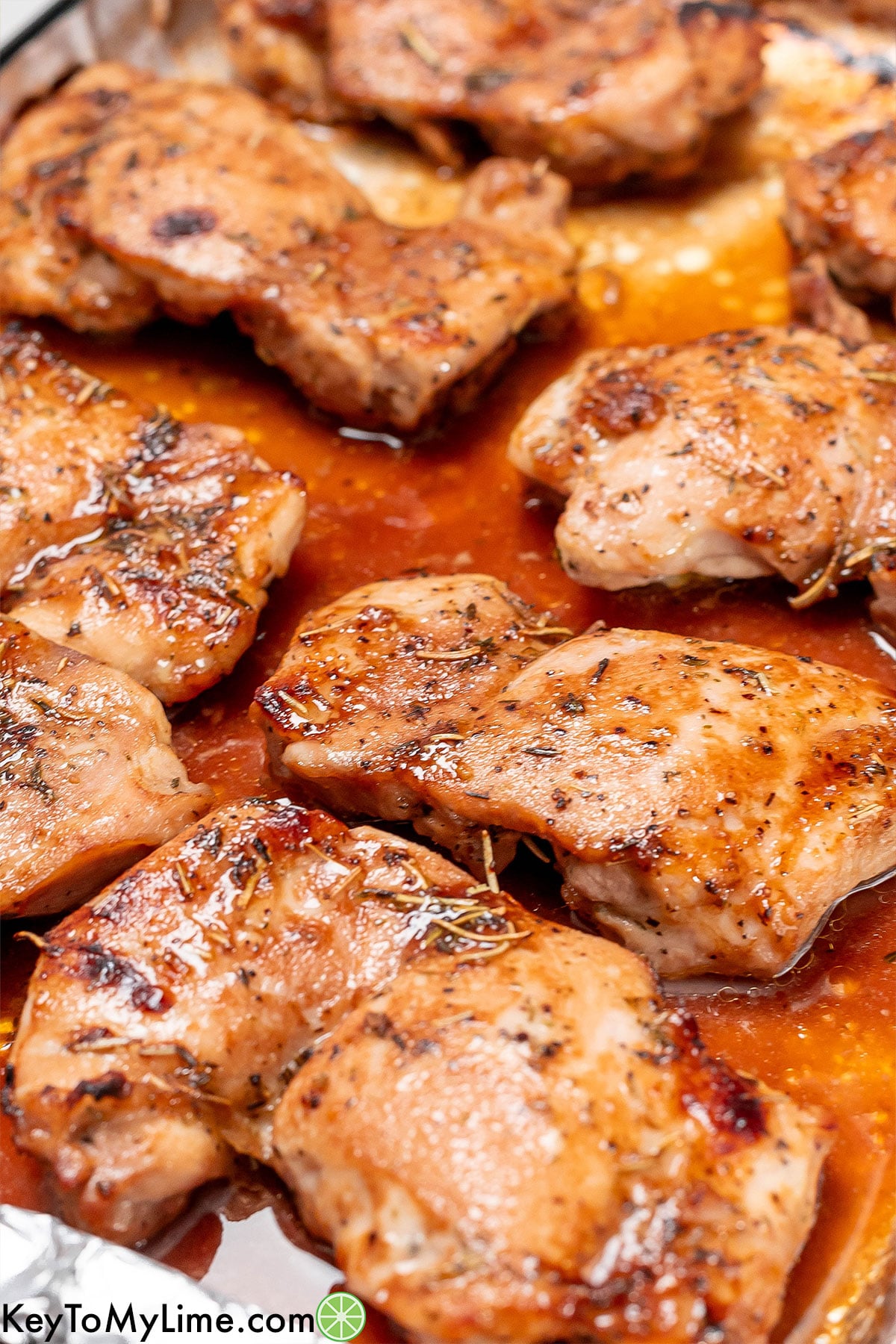 A close up of chicken thighs covered in sauce.