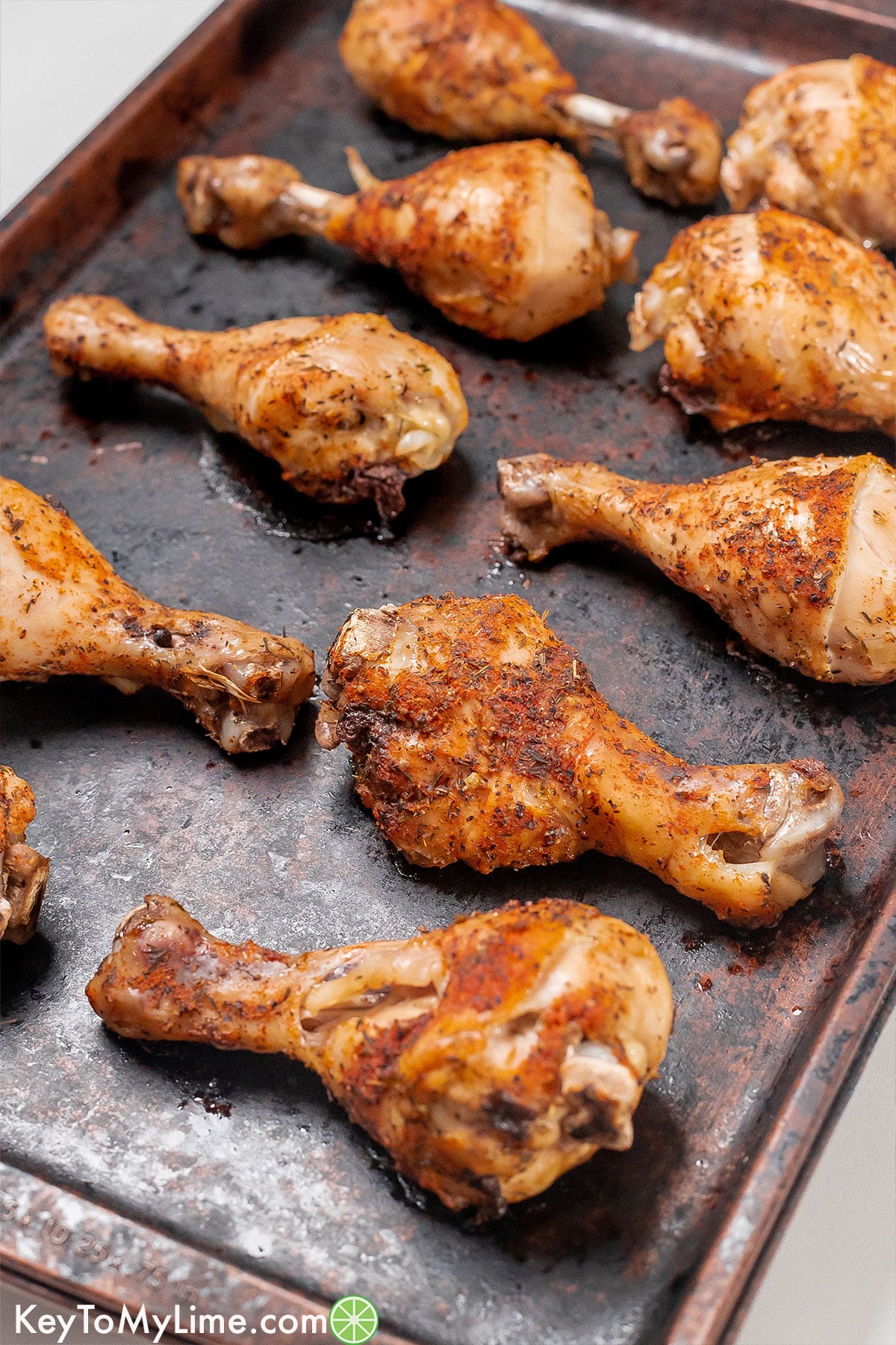 A side image of fully cooked and broiled chicken drumsticks.