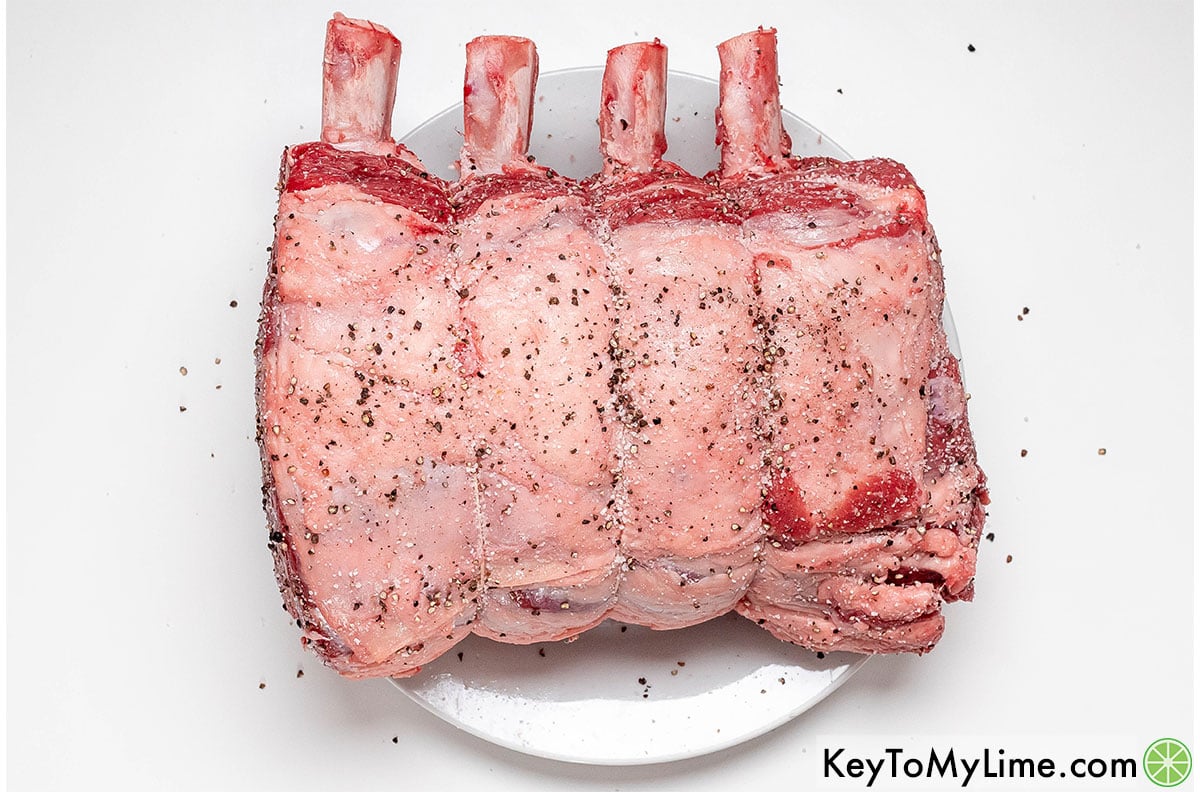 Patting the roast dry, and then seasoning with salt and pepper.