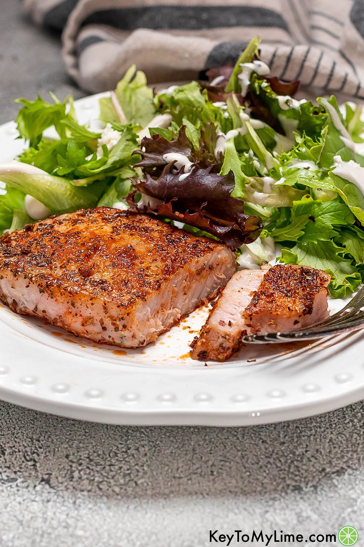 A side image of a perfectly cooked sliced pork chop showing the inside texture.