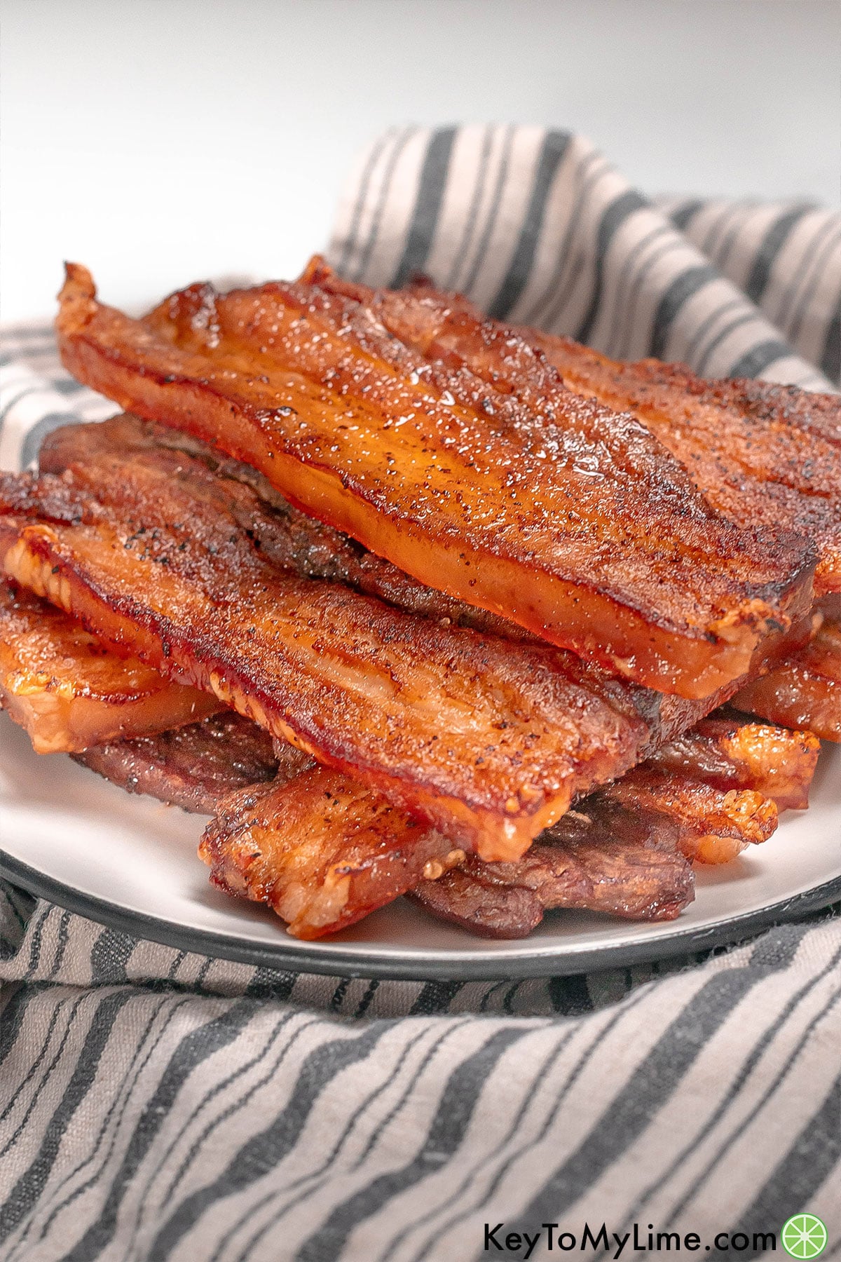 A side image of freshly baked pork belly slices with seasoning throughout.