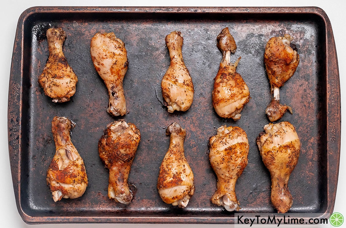 Removing the chicken from the oven after crisping the skin.